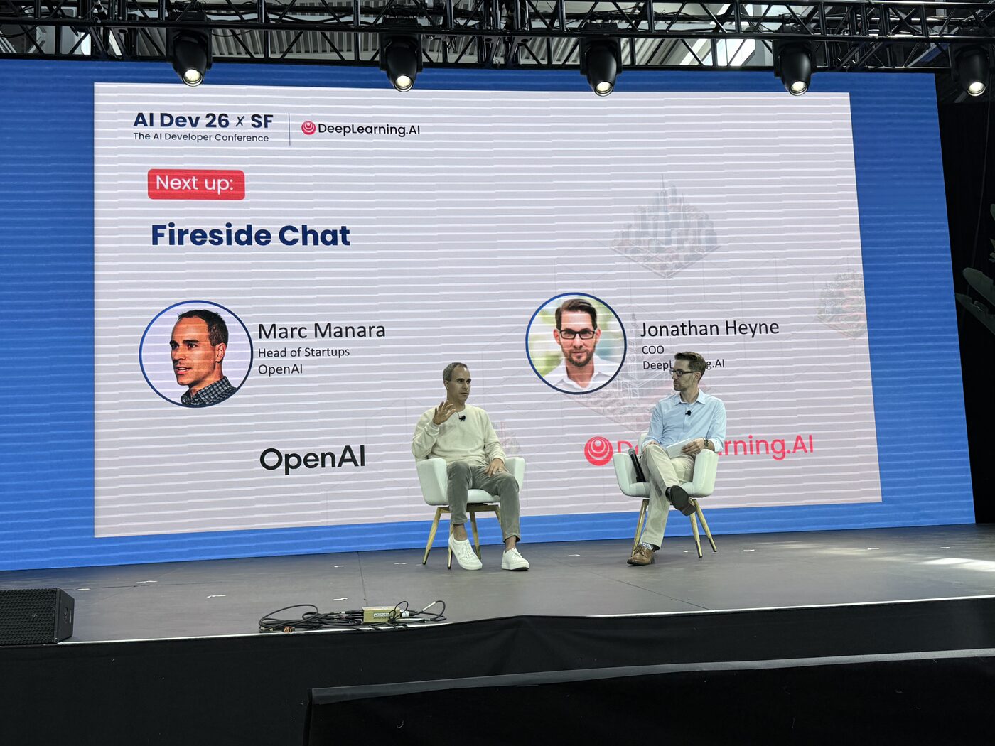 Marc Manara of OpenAI in conversation with Jonathan Heyne of DeepLearning.AI on the main stage